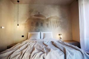 a bedroom with a large bed with two pillows at Casa Nostra Boutique Hotel & Spa in Palermo