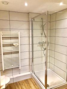 a shower with a glass door in a bathroom at The Paramount, Swindon in Swindon