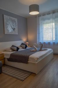 a bedroom with a large bed and a window at Apartman Anabela in Rijeka