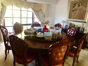 a dining room with a wooden table and chairs at Melbourne Garden Bed and Breakfast in Melton