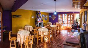 a restaurant with tables and chairs in a room at Villa Betty B&B in Cusco