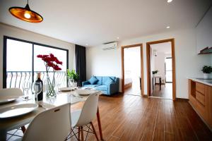 a living room with a table and a blue couch at SAIGON GARDEN HILL Resort & Apartment in Ho Chi Minh City