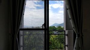 a view from an open window of a balcony at Salmon B&B in Hualien City