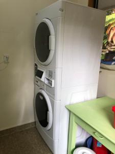 two washing machines are stacked next to each other at Stewart Island Backpackers in Half-moon Bay