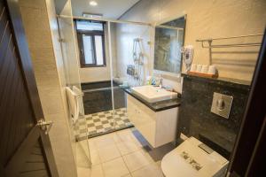 a bathroom with a toilet and a sink and a shower at Salmon B&B in Hualien City