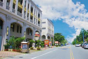 a city street with buildings and cars on the road at Salmon B&B in Hualien City