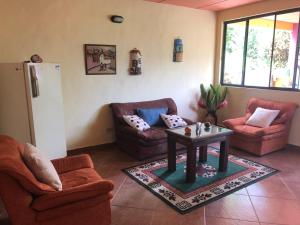 a living room with two couches and a table at finca Las Margaritas in La Vega