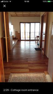 a room with a hallway with a wooden floor and doors at Hillside Village apartment 72sqm size with kitchen in Siquijor