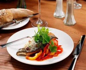 a white plate of food on a wooden table at Your Nottingham Vacation, Business Apart, Parking in Nottingham +28 photos