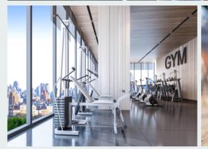 a gym with treadmills and exercise equipment in a building at Your Nottingham Vacation, Business Apart, Parking in Nottingham