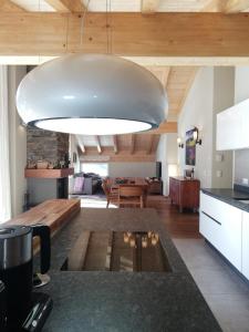 a kitchen and living room with a large light fixture at Pure Hinterthal in Maria Alm am Steinernen Meer
