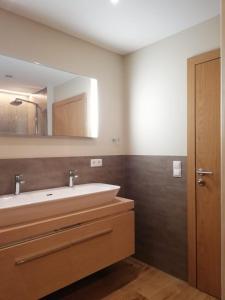 a bathroom with a sink and a mirror at Pure Hinterthal in Maria Alm am Steinernen Meer