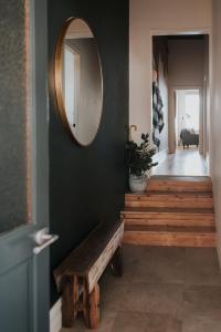 a hallway with a wooden bench and a mirror at Apartments on Belmore -The Ferguson in Yarrawonga