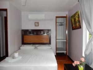 a bedroom with a white bed and a window at Oslob Seafari Resort in Oslob