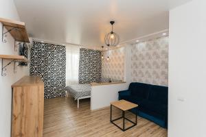 a living room with a blue couch and a table at Elegant apartment 1 in Sumy +3 photos