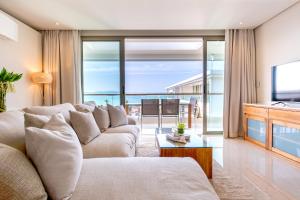 a living room with a couch and a television at Chi - The Residence in Bophut 