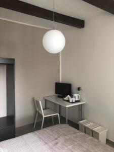 a bedroom with a bed and a desk with a computer at Marconi 11 in Bardello