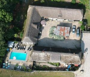 an aerial view of a house with a swimming pool at Farm61 badehotellet i det midtjydske - alder +18 år in Tjele