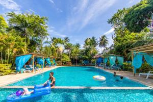 a group of people in a swimming pool at a resort at Baan Kiao in Haad Yao