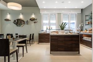 een keuken en eetkamer met een tafel en stoelen bij Hotel Mayer in Lido di Jesolo