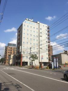 a large white building on the side of a street at Tabist Annex Hotel Tetora Hakodate in Hakodate +129 photos