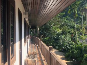 a porch of a house with a dog statue on it at TNP place in Thong Nai Pan Yai