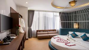 a hotel room with a bed and a couch at Orussey One Boutique in Phnom Penh