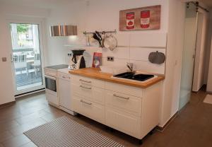 a kitchen with a sink and a stove top oven at Ferienwohnung Sonnentau 2 in Holzminden