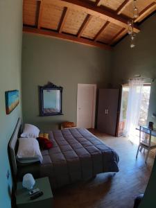 a bedroom with a large bed and a table in it at L.T. METIS in Acireale