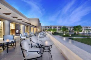 a balcony with tables and chairs on a building at JAZ Mirabel Resort in Sharm El Sheikh