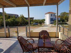 a patio with a table and chairs and a view of a building at Xi House in Xi