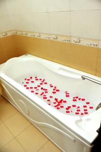 a bath tub with hearts on the side of it at Hanoi Luxury Hotel in Hanoi +59 photos