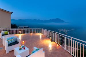 a balcony with a view of the ocean at night at Gala Residence Villa Giovanna in Ravello