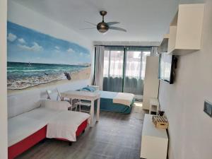 Pokój z 2 łóżkami, kanapą i stołem w obiekcie Apartamento muy cercano a playas y pueblo Puerto del Carmen w Puerto del Carmen
