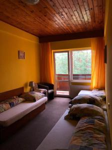 a room with three beds and a window at Penzion Nový mlýn in Staré Splavy