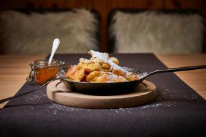 a bowl of food on a table with a spoon at Hanusel Hof Wellness & Genuss in Panoramalage in Hellengerst +80 photos