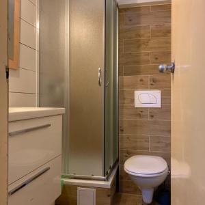a bathroom with a toilet and a glass shower at Rooms Garden in Dubrovnik