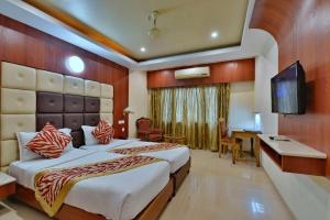 Ένα ή περισσότερα κρεβάτια σε δωμάτιο στο Hotel Sidharth