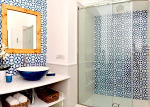 a bathroom with a sink and a glass shower at Gema Suites in Positano