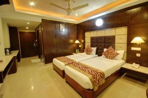Ένα ή περισσότερα κρεβάτια σε δωμάτιο στο Hotel Sidharth
