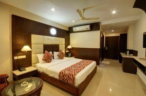 Ένα ή περισσότερα κρεβάτια σε δωμάτιο στο Hotel Sidharth