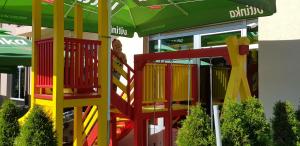 a store front with a colorful play set in front at BOLERO in Pale