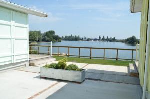 a porch with a view of the water at Premium Lake Lodges in Chichester