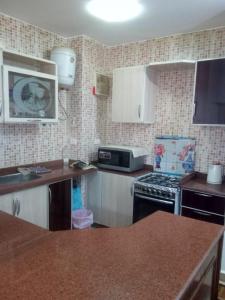 a kitchen with white cabinets and a stove at Blumar Eldome Sea Virw in Ain Sokhna