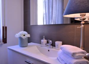 a bathroom with a sink and a lamp and towels at Villa Ettore in Pompei +101 photos