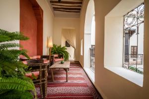 a corridor of a hotel with a table and a couch at Riad Adilah Marrakech - by EMERALD STAY in Marrakesh