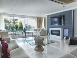 a living room with a couch and a fireplace at Villa Issabella in Marbella