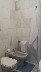 a white bathroom with a toilet and a sink at Verona Amazing River View in Verona +15 photos