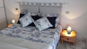 a bedroom with a bed with blue and white sheets and pillows at Verona Amazing River View in Verona
