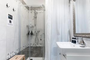 a bathroom with a shower and a sink at Romantic designer apartment Prague in Prague